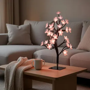 Lite Bulb Moments smart lampa formad som ett körsbärsblommande träd med rosa sken på svart bas för stämningsbelysning i vardagsrummet